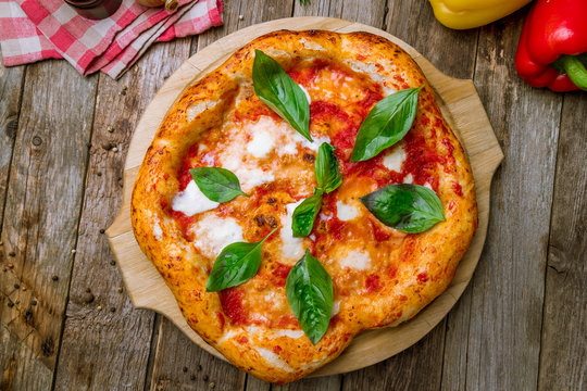 Italian pizza Margherita on wooden background