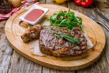 juicy Ribeye steak on wooden background