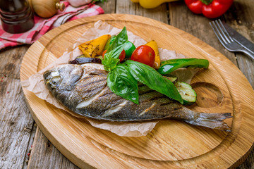 Dorado on grill on wooden background