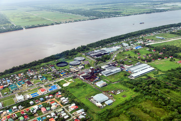 Bird's-eye view of the suburbs of Georgetown and the river Demerara, rum factory, taken from the...
