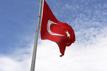 Turkish flag against a blue sky.