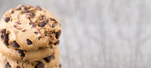 Web banner of sweet chocolate chip cookies on wooden background with copy space