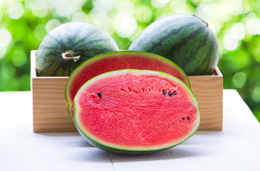 Watermelon cut into pieces on a wooden cutting board placed on the table,Summer fruit that is juicy
