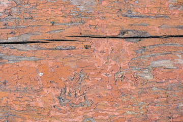 Old wooden peeling board. Old brown painted planks on a house wall. Old color. Weather effects on wood coating.