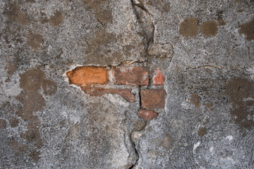 Bricks peaking out of a stone wall in Pisa