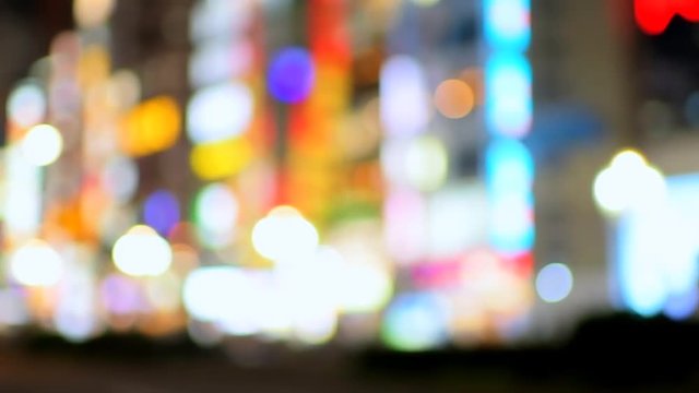 Tokyo, Japan Shinjuku district at night with abstract blurry blurred background of bokeh lights and on street panning urban nightlife in slow motion