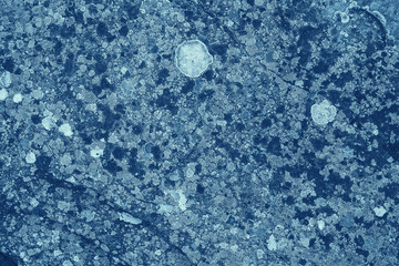 Vintage blue background. Rough painted wall of sapphire color. Imperfect plane of blue colored. Uneven old decorative toned backdrop of cyan tint. Texture of sapphirine hue. Ornamental stony surface.