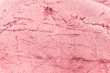 Vintage pink background. Rough painted wall of fiesta color. Imperfect plane of rosy colored. Uneven old decorative toned backdrop of rouge tint. Texture of pink hue. Ornamental stony surface.