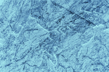 Vintage blue background. Rough painted wall of sapphire color. Imperfect plane of blue colored. Uneven old decorative toned backdrop of cyan tint. Texture of sapphirine hue. Ornamental stony surface.