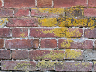 Texture of a brick wall with yellow and red stripes.