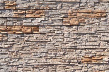 Vintage artificial stone masonry wall,sunlit
