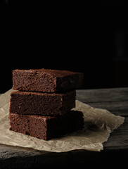 stack of baked square pieces of chocolate brownie cake