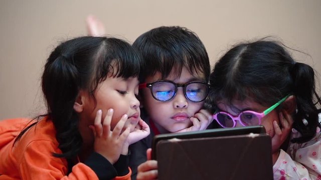 Group of children concentrate watching the video on social media and it is harmful a child's development.