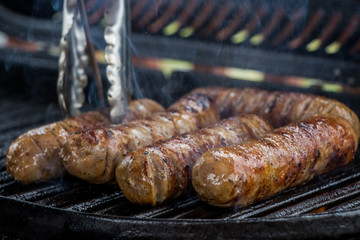 grilling sausages on the barbeque