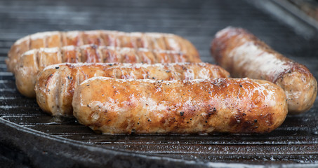 grilling sausages on the barbeque
