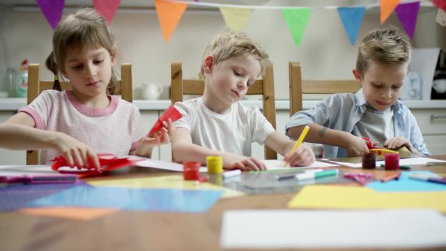 children making craft decorations for holidays