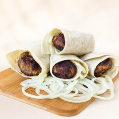 lula kebab from lamb with onion, close up on white background
