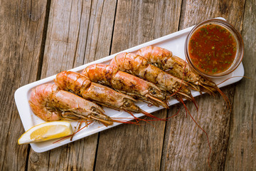 some langoustines on a plate on wooden background