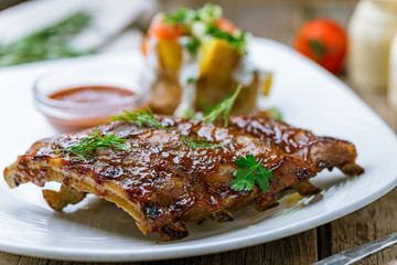 Barbecue pork ribs on wooden background