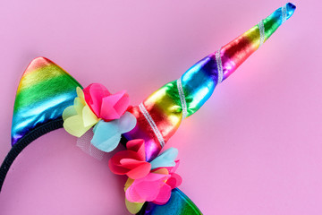 Unicorn Party Headband on pink backgroun. Rainbow Color Horn For Children.