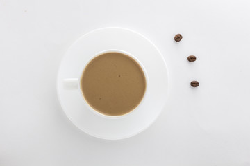 White cup of hot coffee and coffee beans..