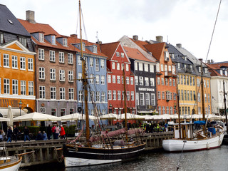 Nyhavn with colorful facades of old houses and old ships in the Old Town of Copenhagen