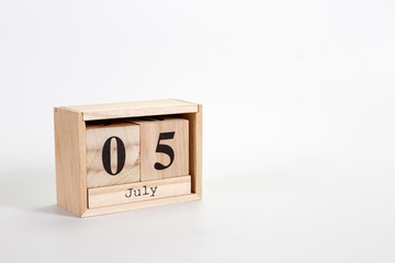 Wooden calendar July 05 on a white background