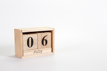 Wooden calendar July 06 on a white background