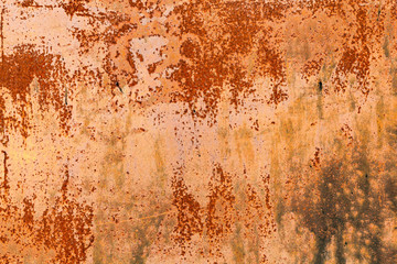 Rusty yellow-red textured metal surface. The texture of the metal sheet is prone to oxidation and corrosion. Textured background in grunge Style
