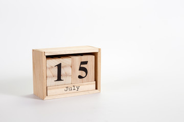 Wooden calendar July 15 on a white background