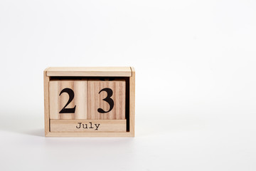 Wooden calendar July 23 on a white background