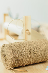 reel with string for gift wrapping on wooden table