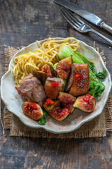 Oriental duck fillets with sticky figs, pak choi and egg noodles - top view