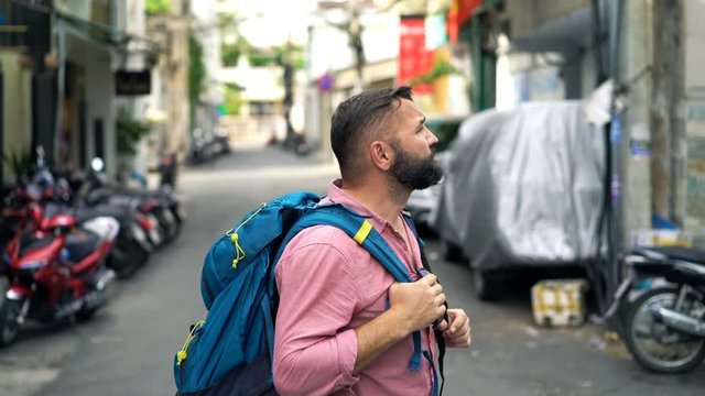 Young man, lost traveler, backpacker in the city