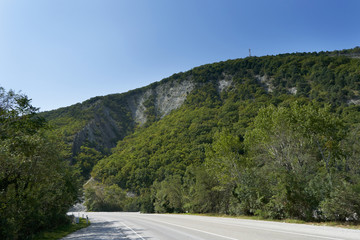 Big mountain covered with trees against the blue sky. Beautiful mountain in the vicinity of Geledzhik, Russia