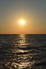 Beautiful orange sunset in the black sea with sun reflection in the city of Gelendzhik, Russia