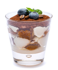 Classic tiramisu dessert with blueberries in a glass isolated on a white background with clipping path