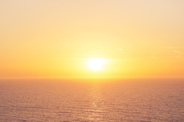 Orange sunset over Mediterranean Sea. Beautiful sunset over calm ocean. Sunrise or sunset over the sea with retro filter effect, summer concept