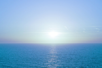 Blue sunrise or sunset over the sea with retro filter effect, summer concept. Blue sunset over Mediterranean Sea. Beautiful sunset over calm ocean.