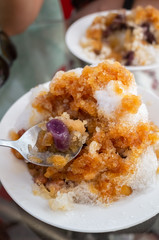 eating shaved ice with colorful dessert