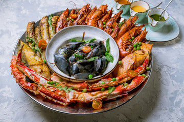 Seafood grilled on plate on grey concrete