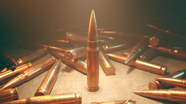 Closeup of the one standing bullet in the spotlight surrounded by scattered ammo
