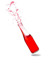 Red soda splashing out of glass bottle isolated on white background.