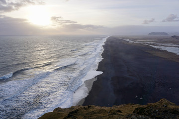 Dark sand volcanic beach and sea