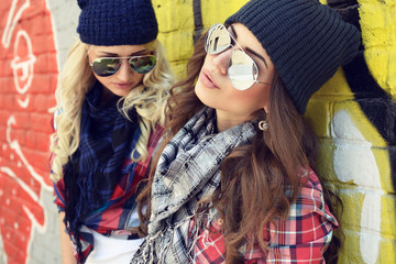 Young pretty hipster girls having fun outdoor, summer on the street. Teenage lifestyle. Trendy...