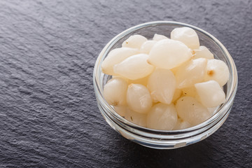 pickled vegetables on a dark stone background