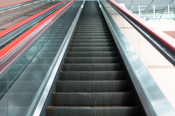 Escalator in shopping mall. Moving up and down staircase. electric escalator.