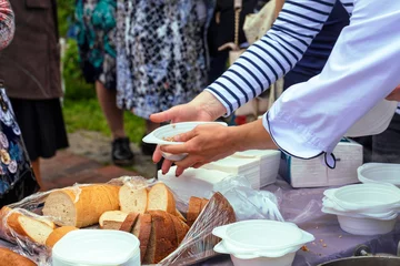 Foto op Canvas Social workers distribute food to poor elderly people. © Sergii