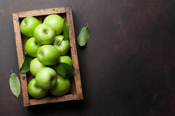 Green apples in wooden box