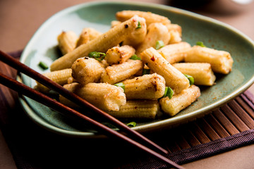 Baby Corn Manchurian dry - popular Indo-chinese starter recipe. selective focus